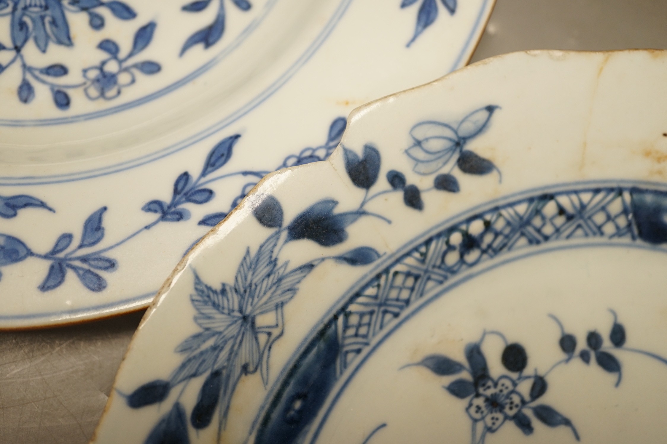 Four Chinese 18th century plates and a late 19th century blue and white dragon plate, largest 24cm diameter